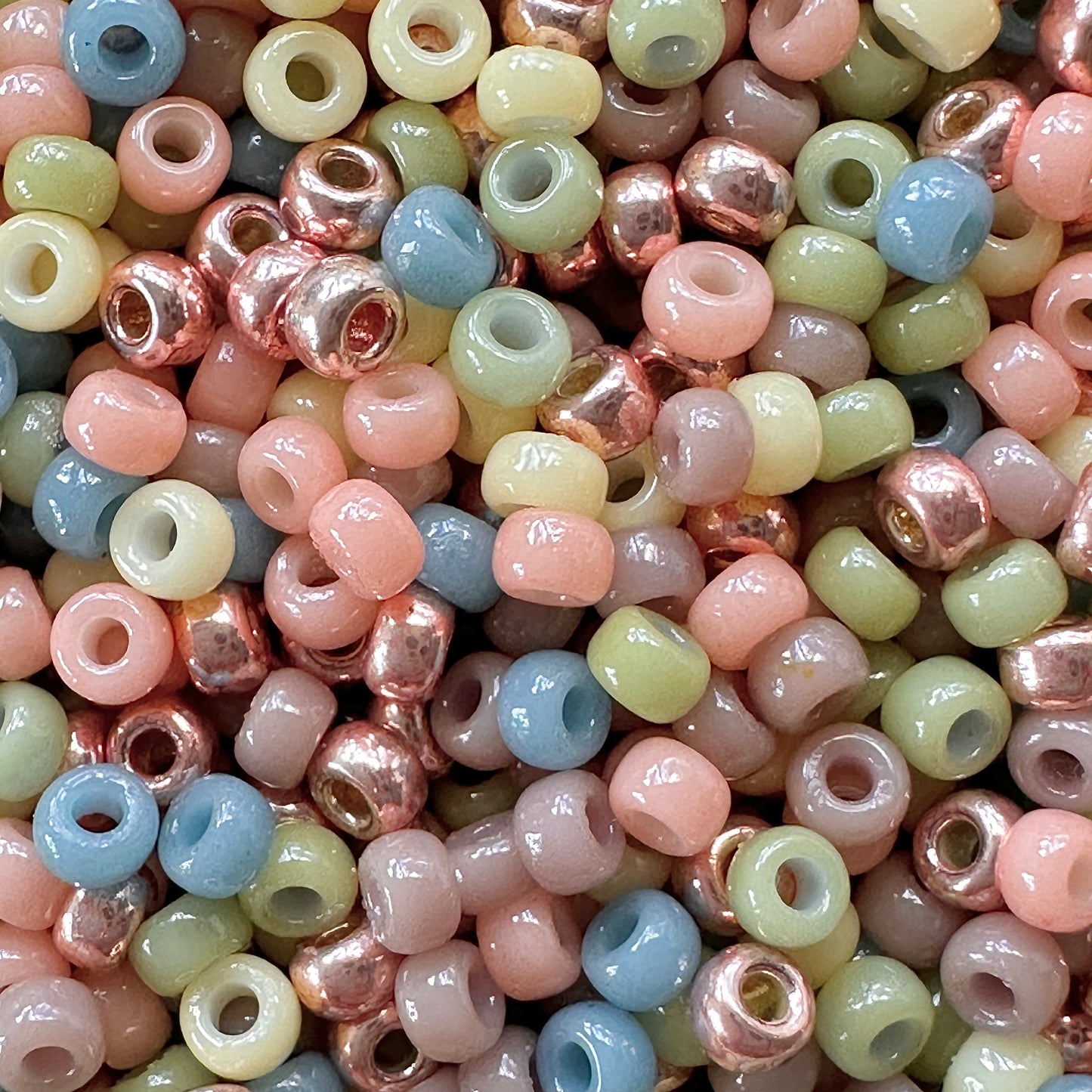 Pastel mix of Miyuki 11/0 seed beads by The Bead featuring pastel shades of peach, yellow, green, blue, and purple.