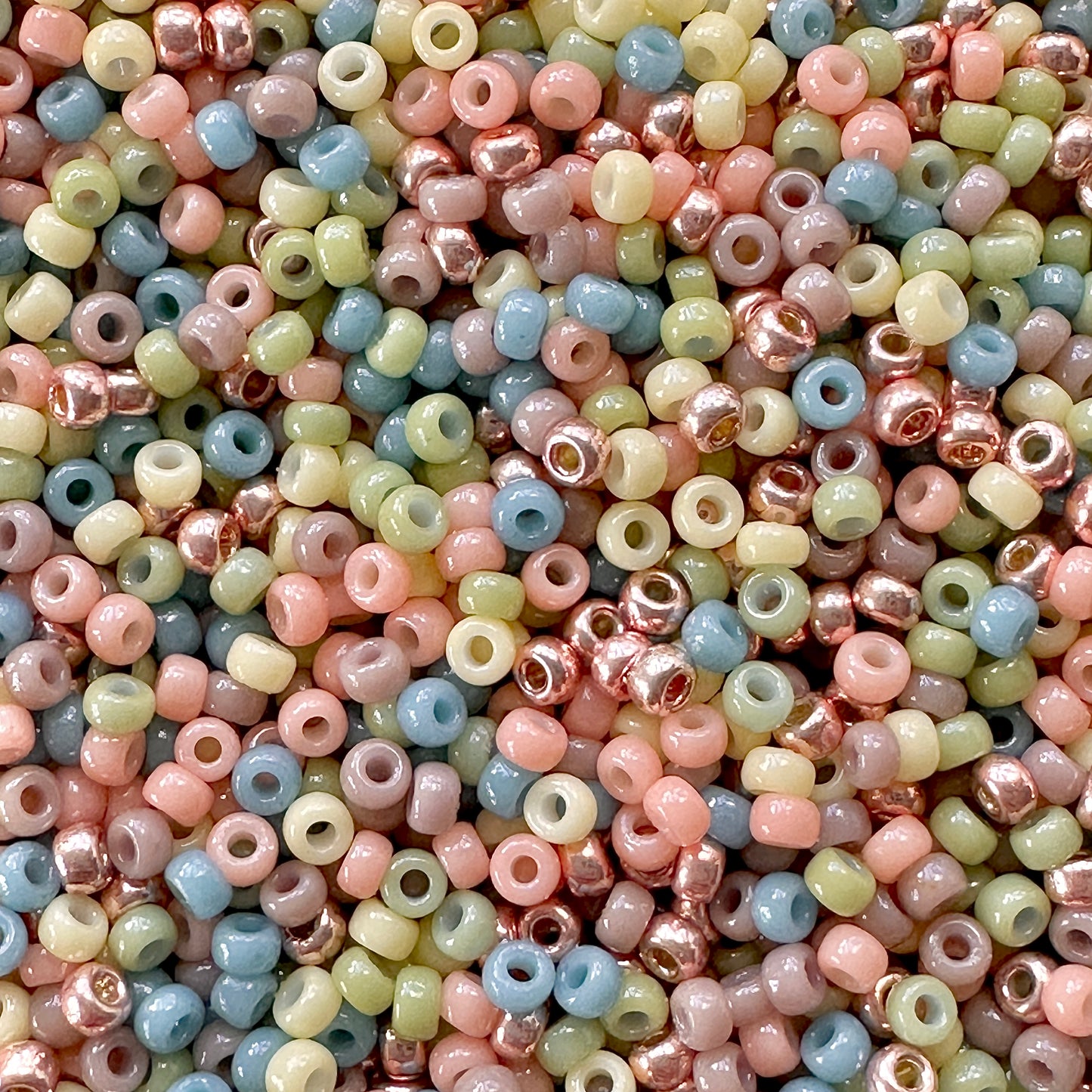 Pastel mix of Miyuki 11/0 seed beads by The Bead featuring pastel shades of peach, yellow, green, blue, and purple.