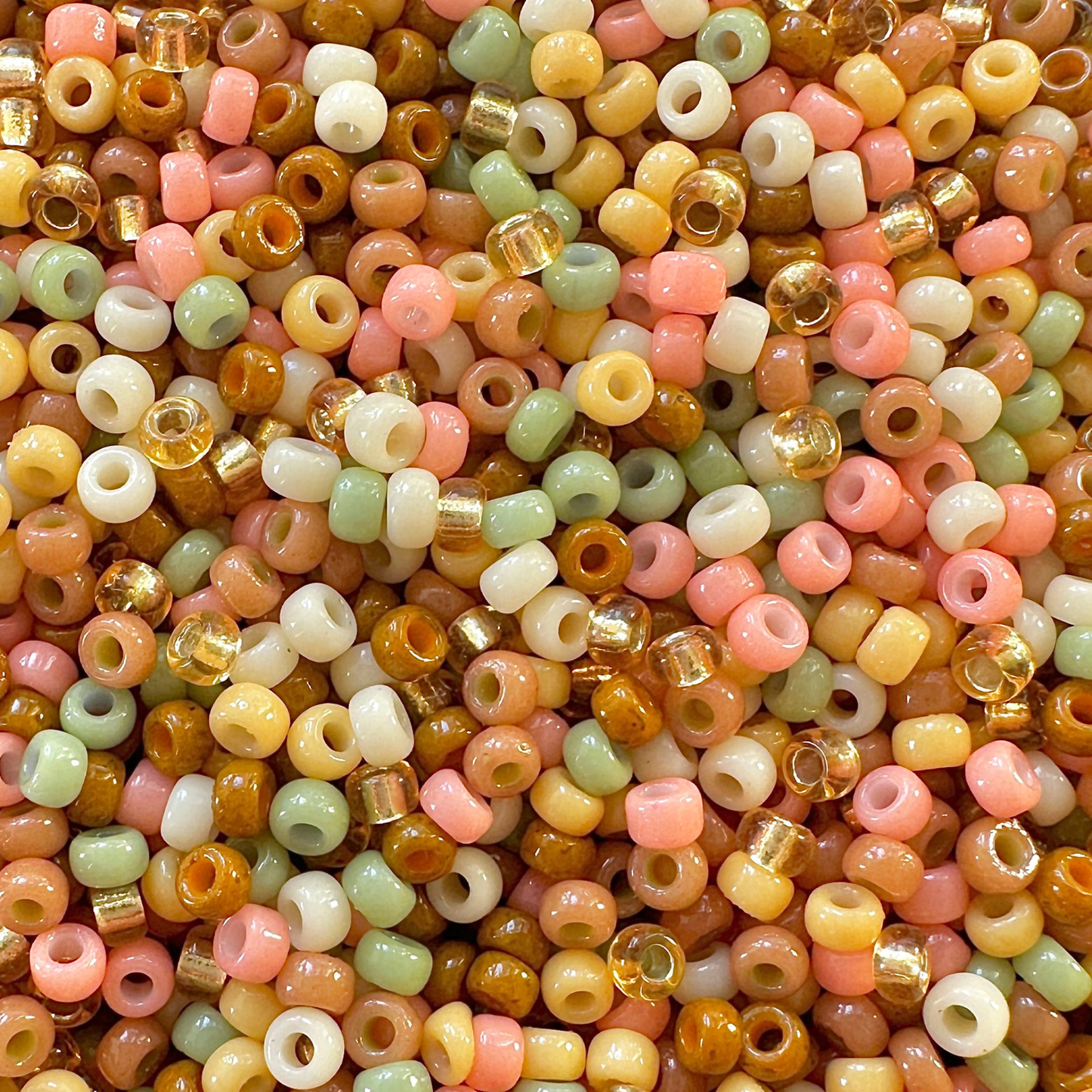 Mix of Miyuki seed beads in shades of shades of cream, peach, brown, peach, and green for a Gingerbread Miyuki Bead Color Palette.