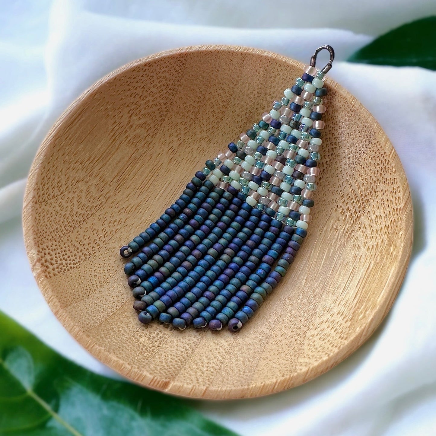 Beaded fringe earring made with Miyuki 11/0 seed beads with multicolor brick stitch and matte black rainbow fringe
