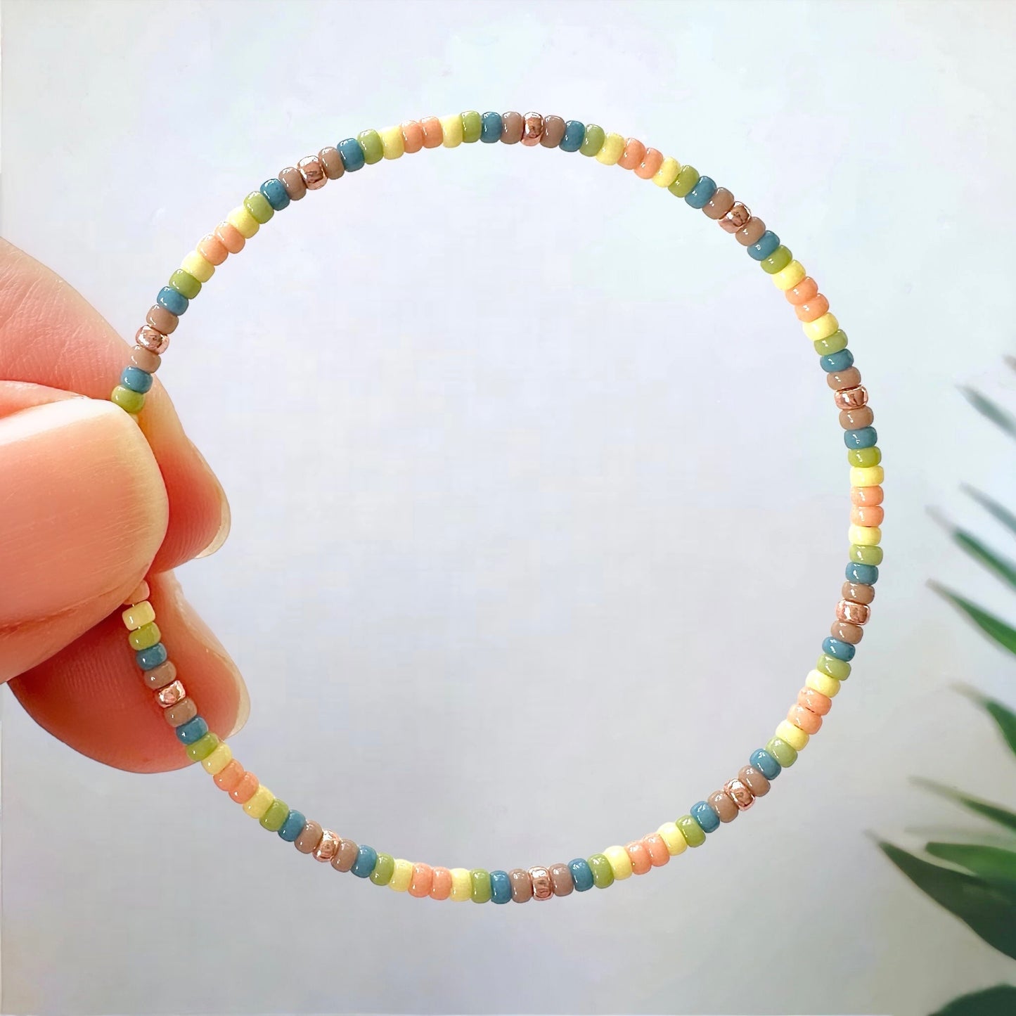 a beaded hoop made with 11/0 Miyuki seed beads in pastel colors