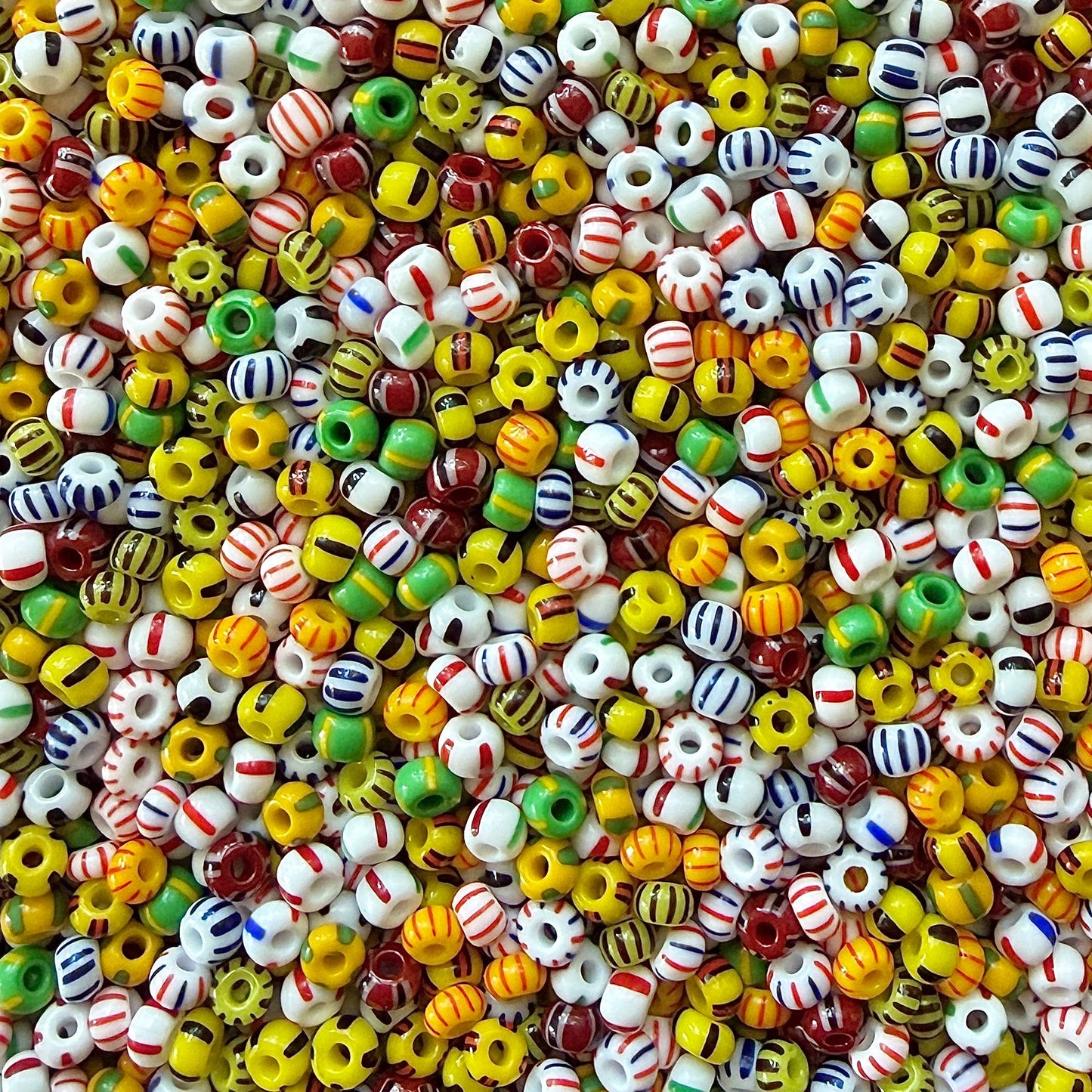 Mix of striped Czech 6/0 seed beads in yellow, green, black, white, red, and blue.