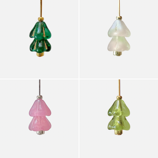 Four hanging beaded Christmas tree charms in green, white, and pink arranged in a 2x2 grid on a light gray background.