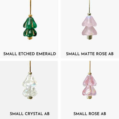 Four hanging beaded Christmas tree charms in green, pink, and crystal AB arranged in a 4x4 grid on a light gray background.