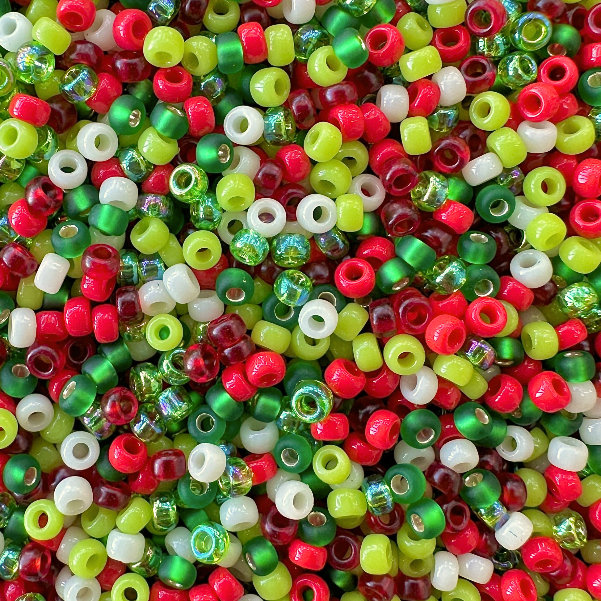 Mix of Miyuki seed beads in shades of red, green, and cream for a Grinch Miyuki Bead Color Palette.