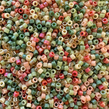 Mix of Miyuki seed beads in shades of green, red, peach, cream and gold.