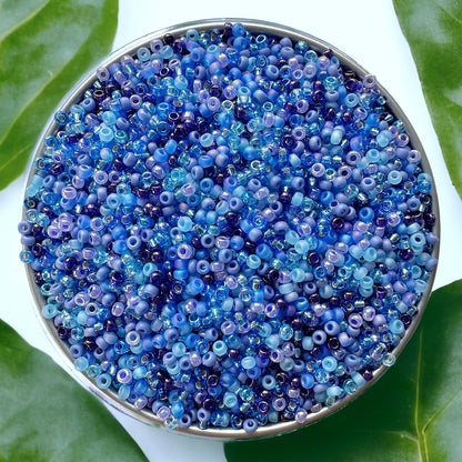 Video of pouring blue Miyuki 11/0 seed beads in a white ceramic dish on a white wood surface
