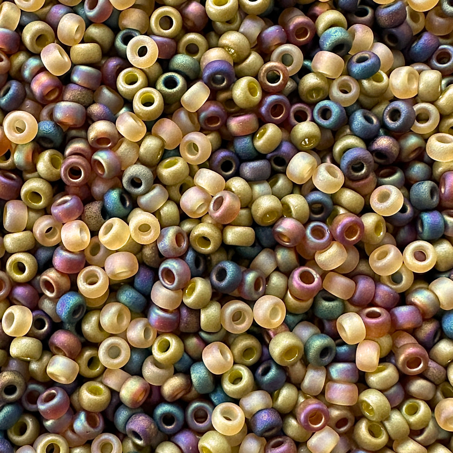 Mix of Miyuki seed beads in shades of shades of green and iridescent black and topaz.