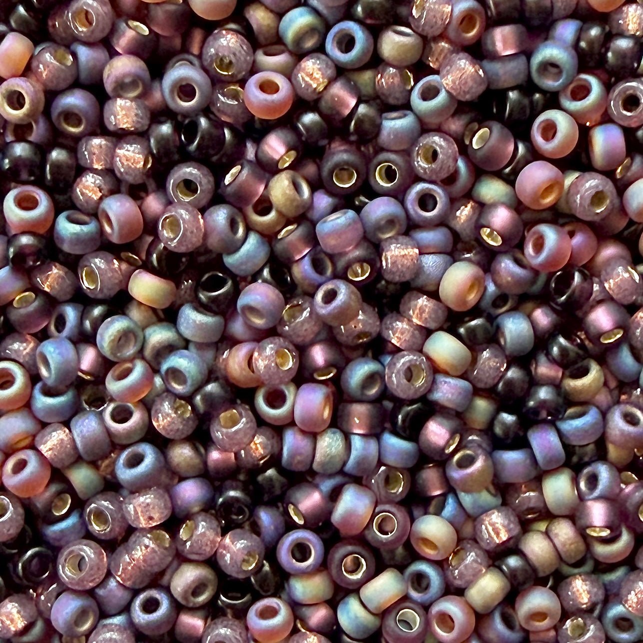 Mix of Miyuki 11/0 round seed beads in shades of plum and mauve with various finishes.