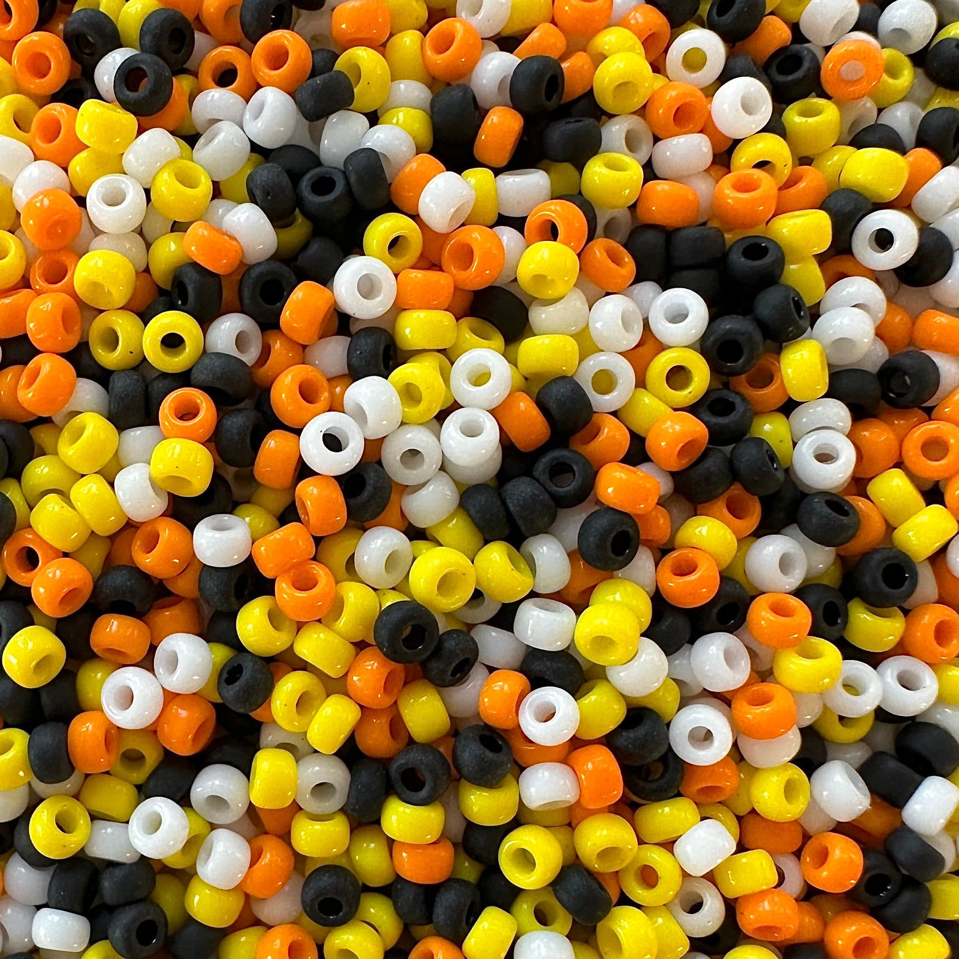 Mix of candy corn colored Miyuki 11/0 seed beads, including yellow, orange, white, and black created by The Bead Mix