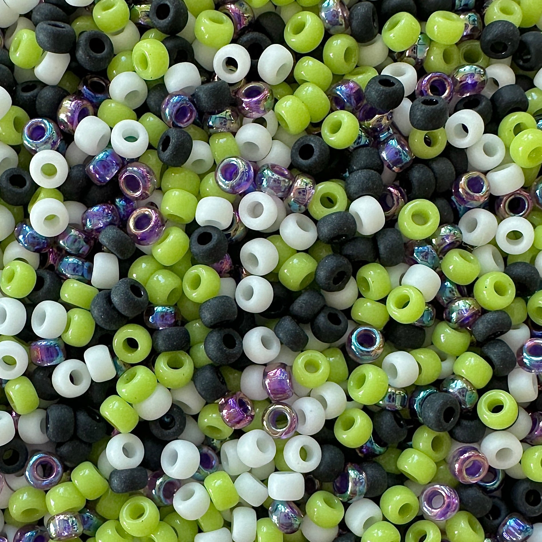 Mix of purple, black, white, and green Miyuki 11/0 seed beads by The Bead Mix